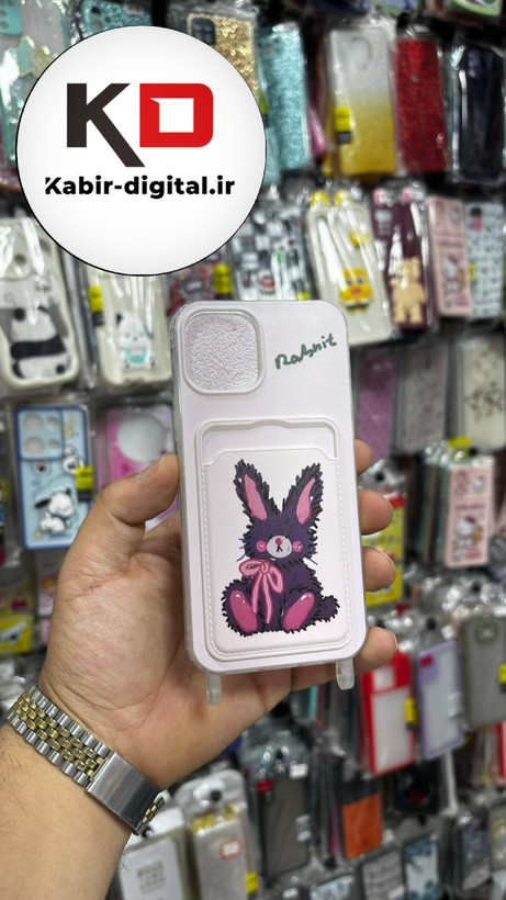 قاب گوشی iPhone 12 Pro آیفون اورجینال ژله ای جاکارتی دار کپسولی به همراه بند آویز دوطرفه طرح خرگوش کیوت