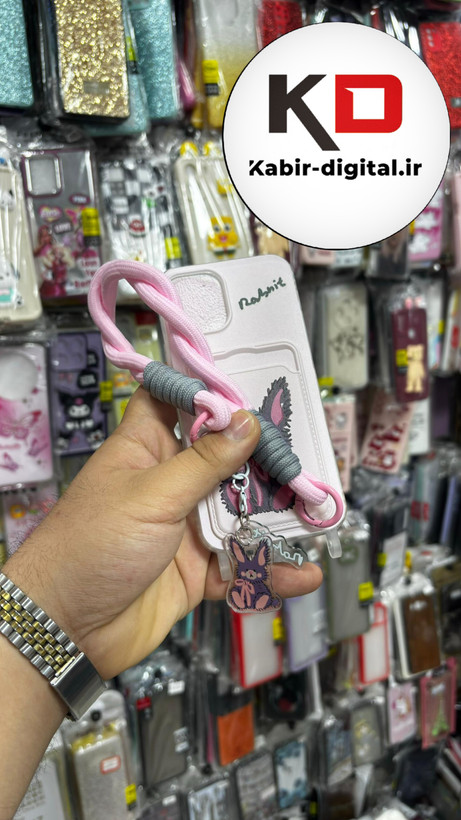 قاب گوشی iPhone 12 Pro آیفون اورجینال ژله ای جاکارتی دار کپسولی به همراه بند آویز دوطرفه طرح خرگوش کیوت