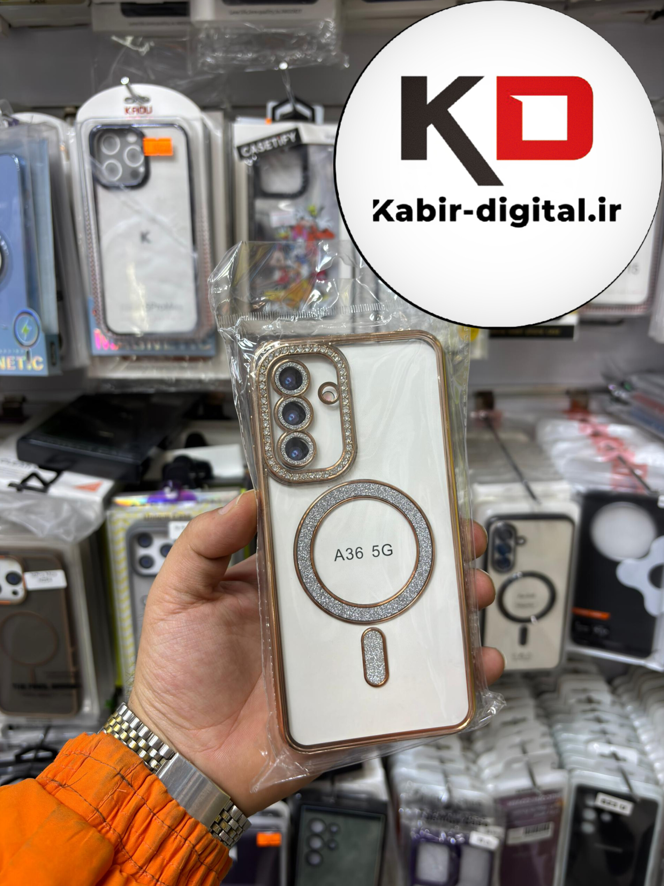 قاب گوشی Galaxy A36 سامسونگ الکتروپلیتینگ ژله ای شفاف اورجینال طرح مگ سیف محافظ لنز دار نگین دار طلایی
