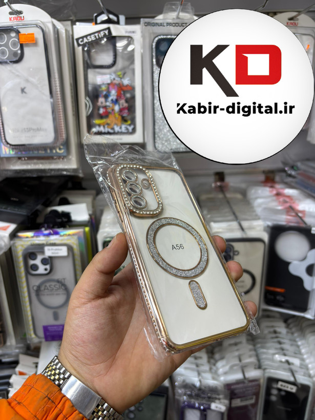 قاب گوشی Galaxy A56 سامسونگ الکتروپلیتینگ ژله ای شفاف اورجینال طرح مگ سیف محافظ لنز دار نگین دار طلایی