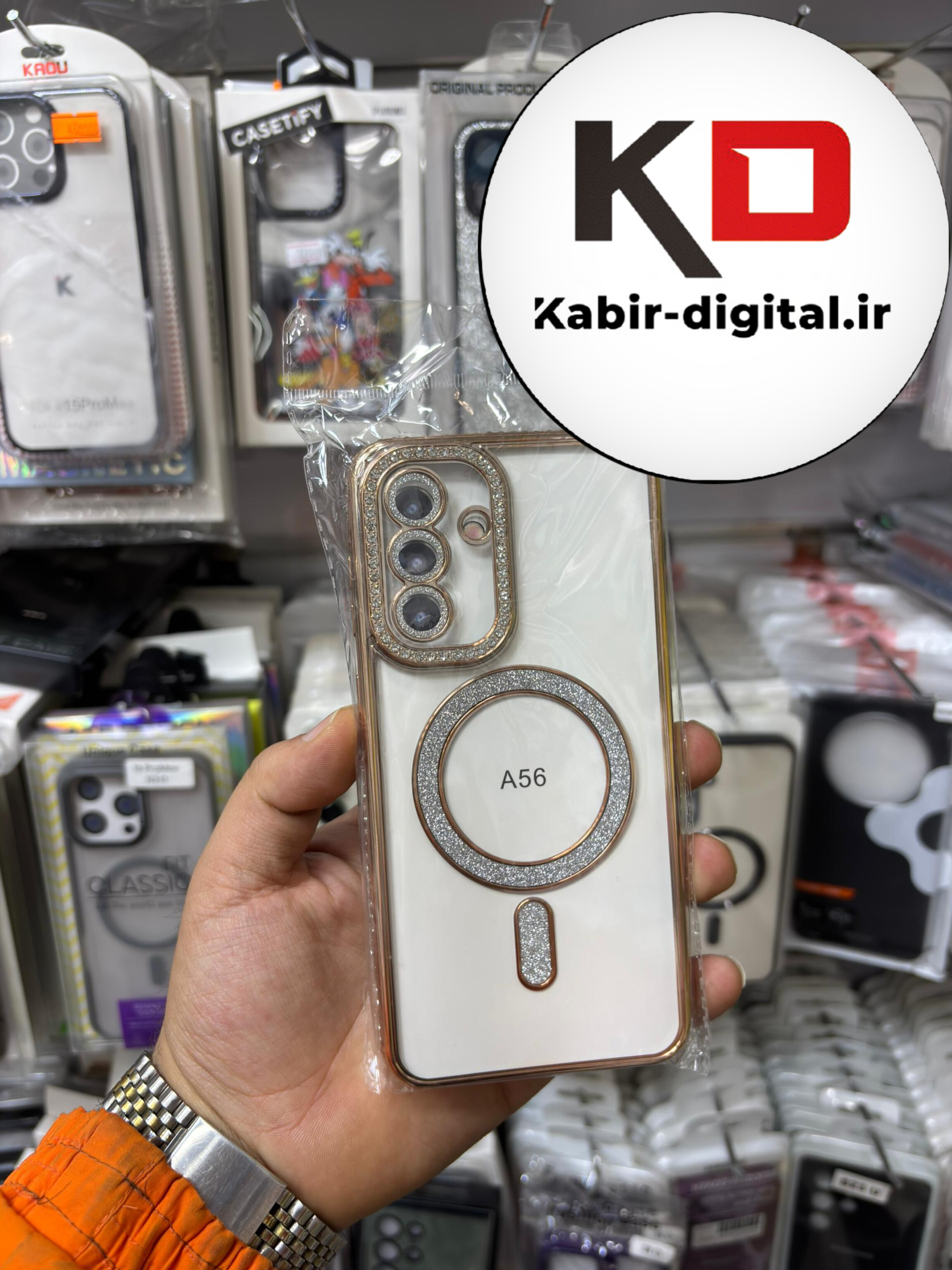 قاب گوشی Galaxy A56 سامسونگ الکتروپلیتینگ ژله ای شفاف اورجینال طرح مگ سیف محافظ لنز دار نگین دار طلایی